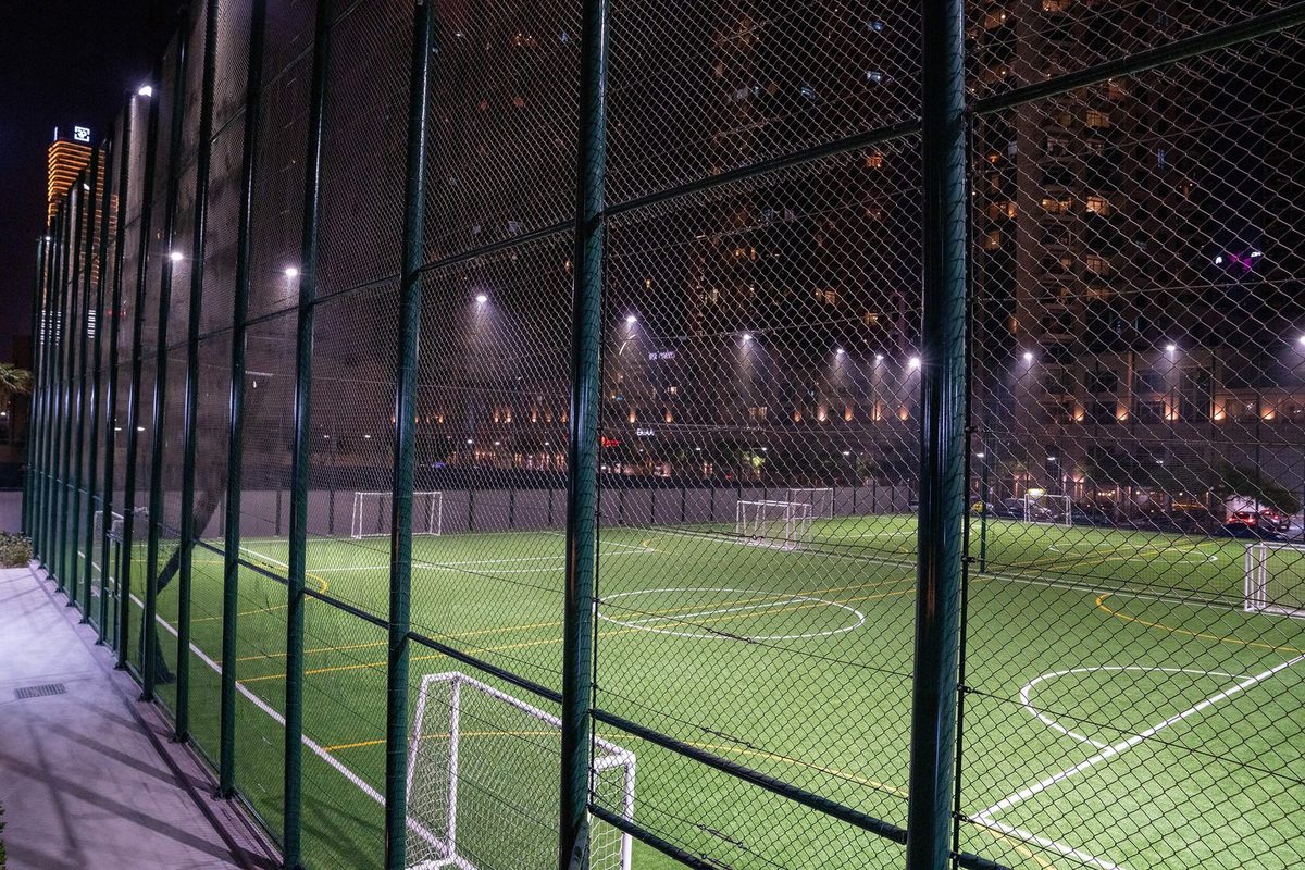 Empty pitch at dusk against the Downtown skyline